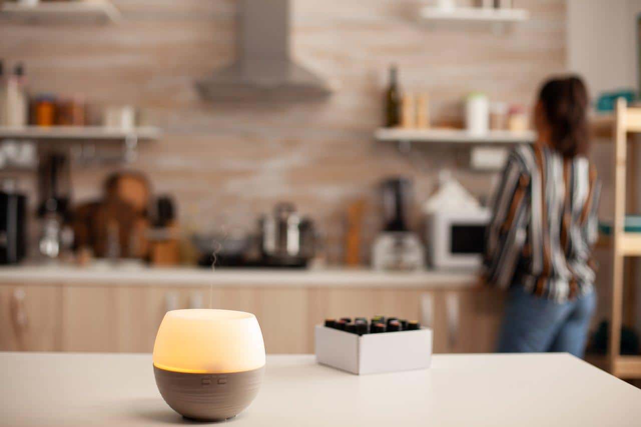 Diffuseur d'huiles essentielles en espace zen, favorisant relaxation et méditation avec lavande, bois de santal et encens.